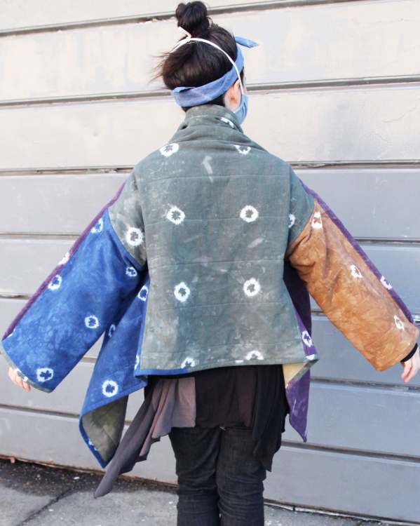 back view of woman wearing colorful hand dyed quilt coat