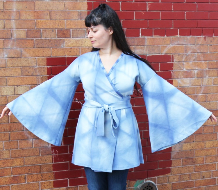 woman wearing blue shibori wrap top with bell sleeves