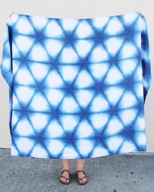 woman wearing large blue and white shibori dyed linen shawl