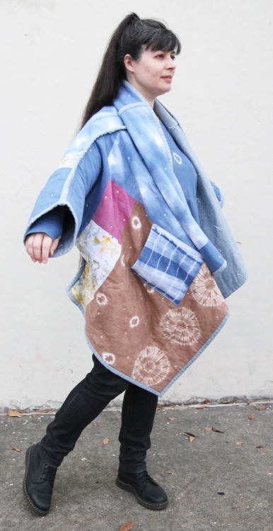woman wearing colorful hand dyed patchwork quilt coat