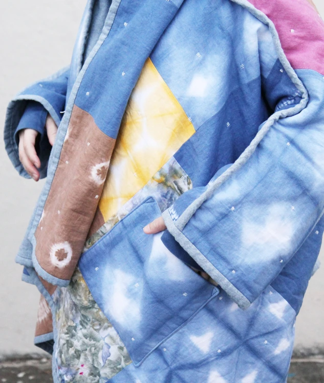 woman wearing colorful hand dyed patchwork quilt coat